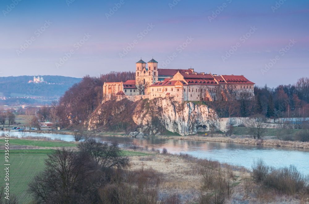 Fortified medieval Benedictine abbey in Tyniec, suburb of Krakow, over Vistula river in the evening