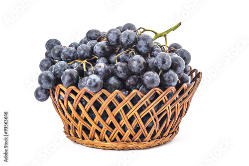 Ripe red grapes in woven basket isolated on a white