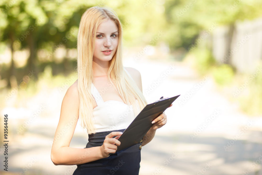 Portrait of pretty student or businesswoman in smart casual using tablet outdoors Portrait of pretty student or businesswoman in smart casual using tablet outdoors