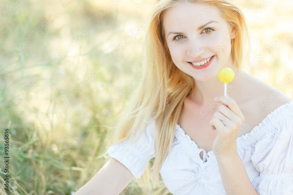 Young sexy woman sucking lollipop. Urban style. Outdoors, lifestyle. Young sexy woman sucking lollipop. Urban style. Outdoors, lifestyle.