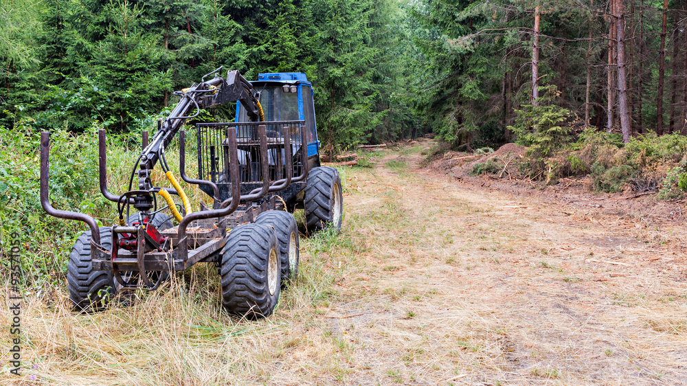 Logging machine parked nearby forest path Logging machine parked nearby forest path