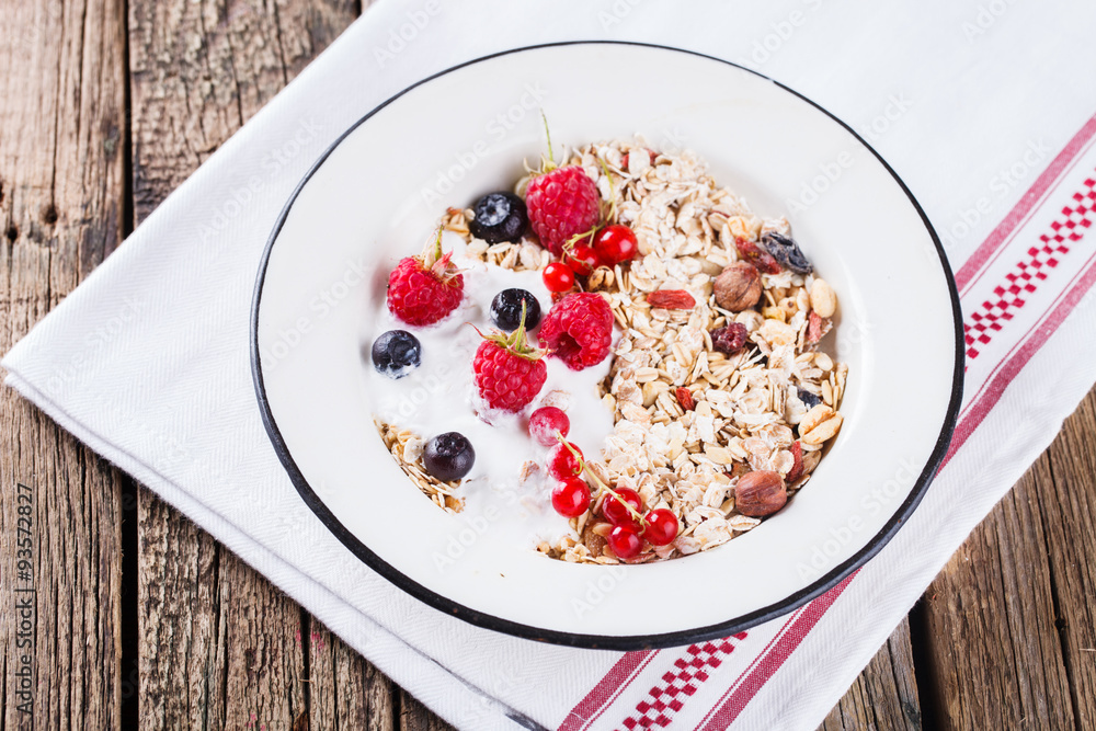 Granola, muesli , honey, yogurt and fresh berries .Healthy breakfast.selective focus Granola, muesli , honey, yogurt and fresh berries .Healthy breakfast.selective focus