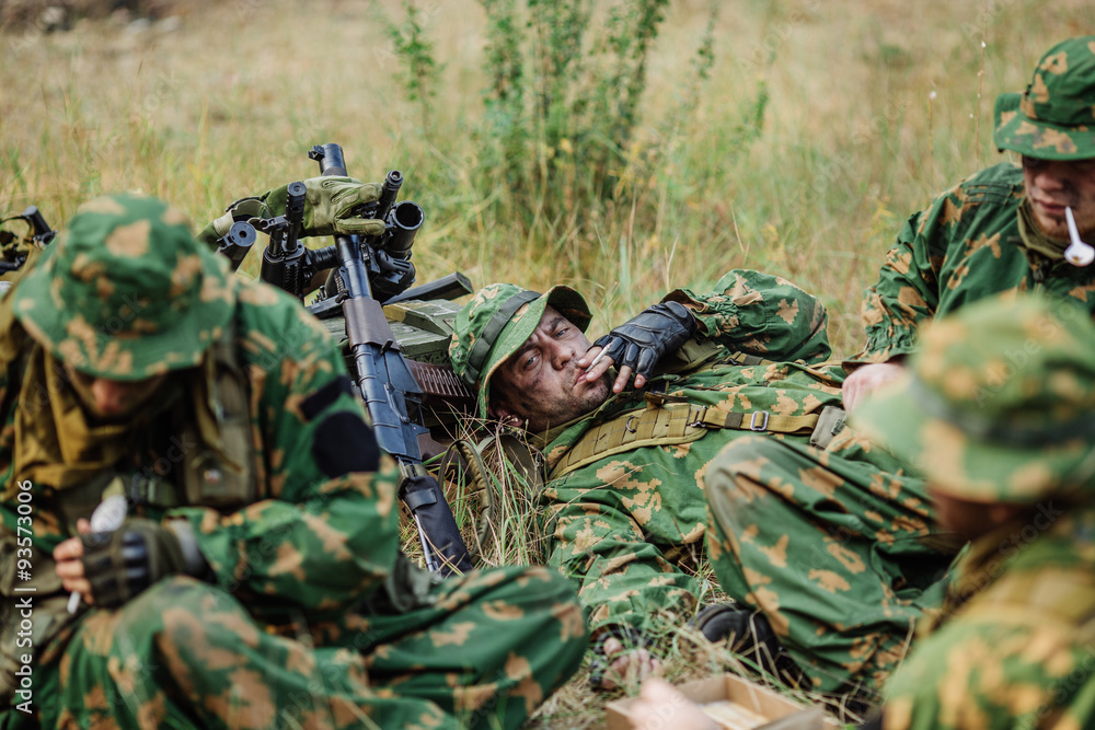 soldiers team are heated food on the fire and eat in the forest