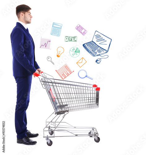Young man pushing empty shopping cart with different icons, isolated on white