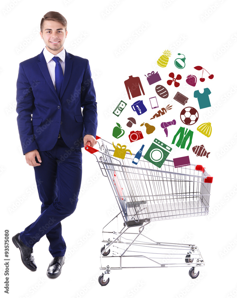 Young man holding empty shopping cart with different icons, isolated on white Young man holding empty shopping cart with different icons, isolated on white