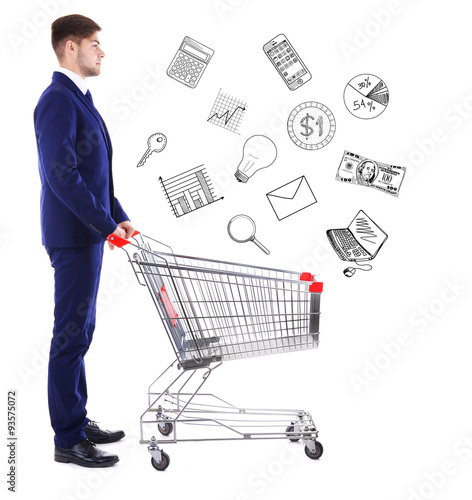 Young man pushing empty shopping cart with different icons, isolated on white