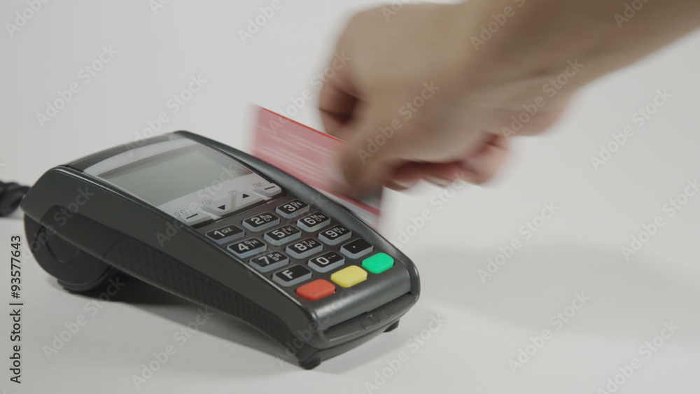 Hand swiping credit card on POS terminal Hand swiping credit card on POS terminal