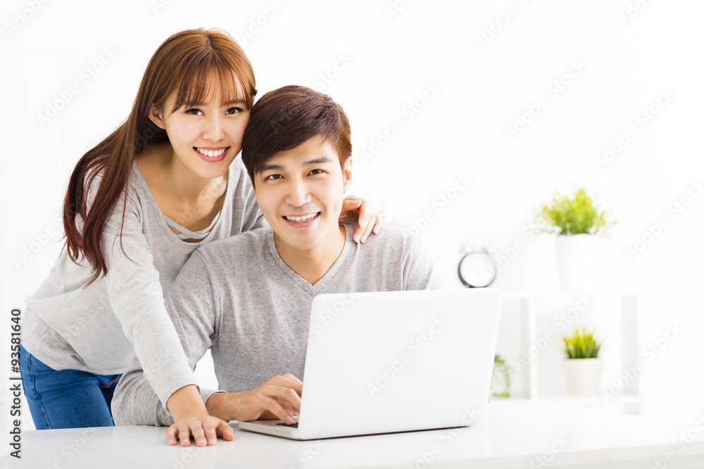 happy young Couple with Laptop In living room