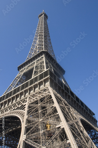 Elevator climbs the lower leg of Eiffel Tower.Paris, France