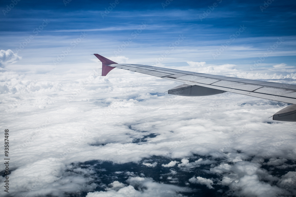 Fototapeta premium View of cloud sky and wing of airplane from window