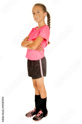 Young girl soccer player standing with her arms folded