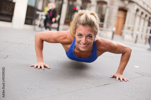 young woman exercising doing push ups