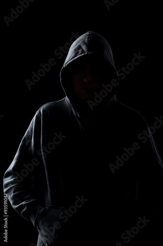 Faceless guy in hoodie in the darkness