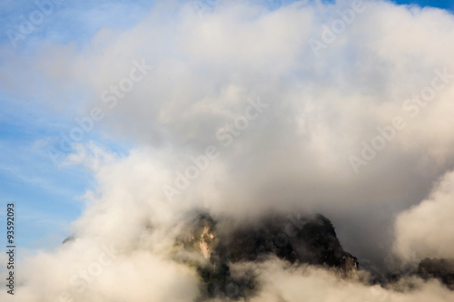 islands and mountains covered by clouds and fog in the morning of the sunny day in warm tone.