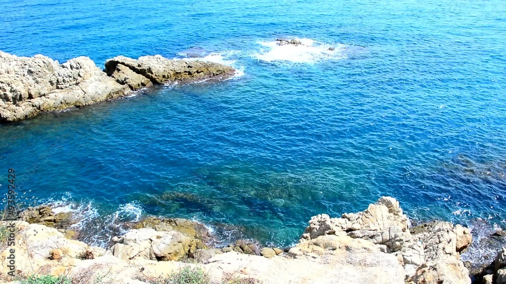 Static high definition shot of the mediterranean sea waves splashing against the rock on the coast. Static high definition shot of the mediterranean sea waves splashing against the rock on the coast.