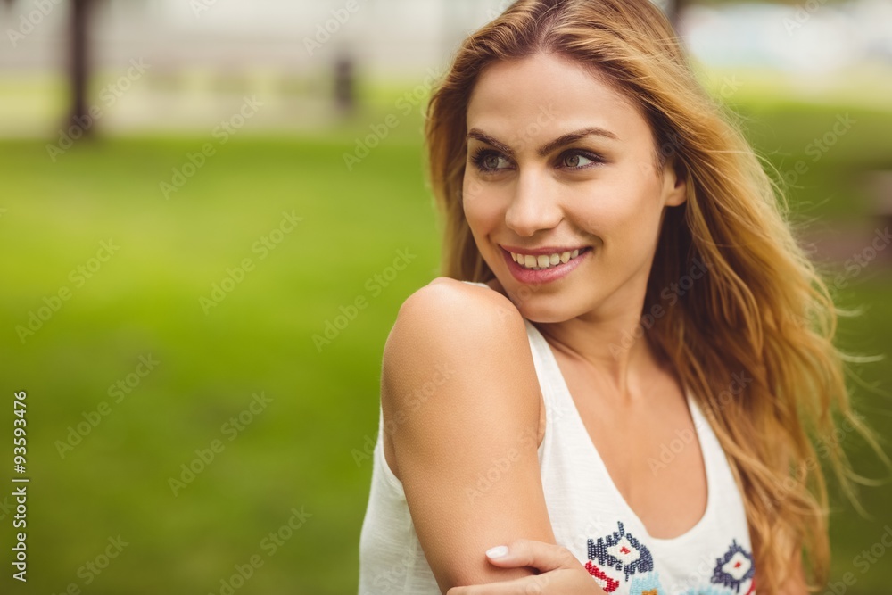 Cheerful woman looking away while standing on grass Cheerful woman looking away while standing on grass