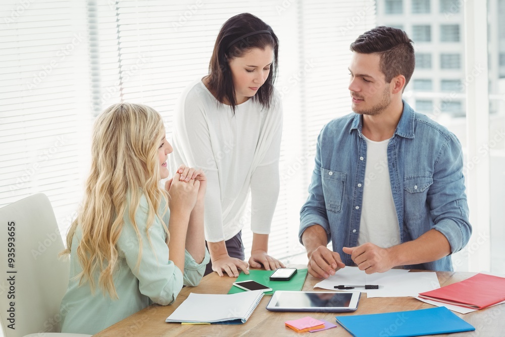 Business professionals discussing at desk 