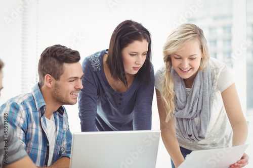 Business people using laptop at desk 