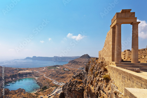 Greece. Rhodes. Acropolis of Lindos. Doric columns of the ancient Temple of Athena Lindia the IV century BC and the bay of St. Paul photo
