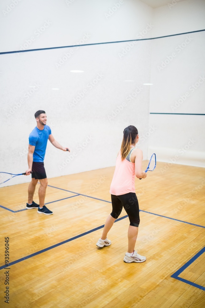 Couple playing a game of squash Couple playing a game of squash
