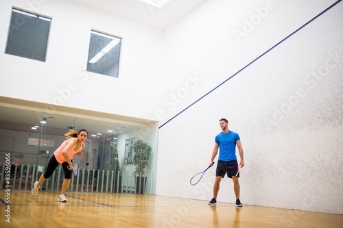 Couple playing a game of squash