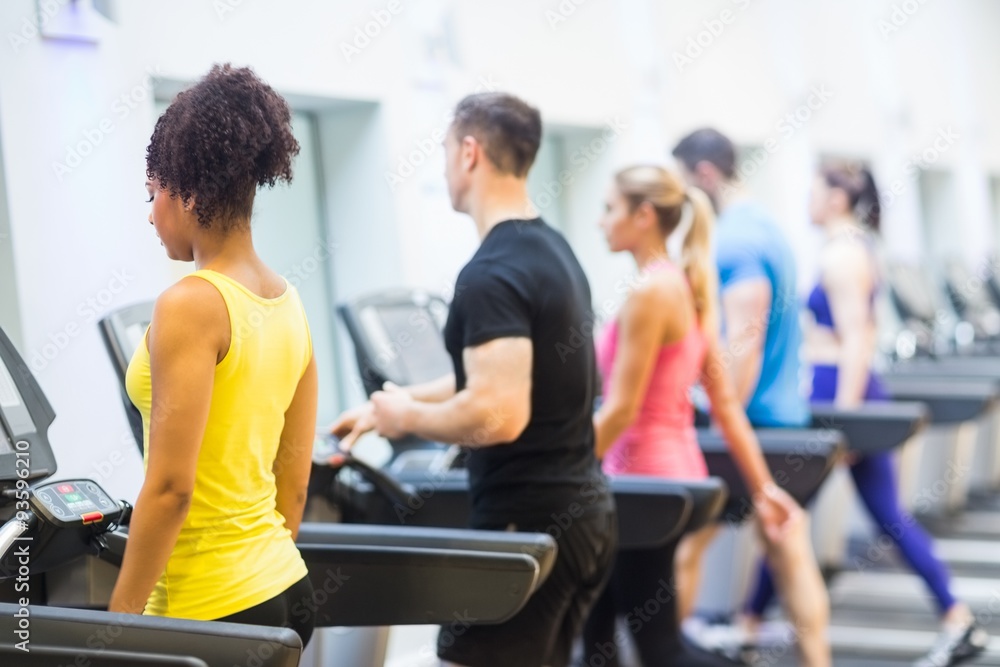 Obraz premium Fit people walking on treadmills
