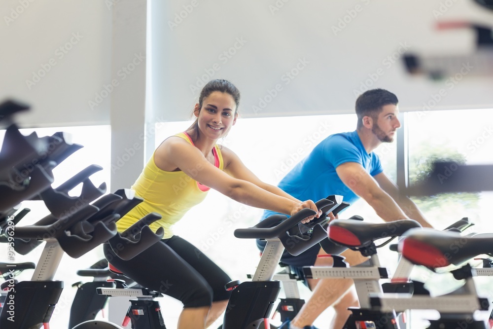 Couple using exercise bikes together Couple using exercise bikes together