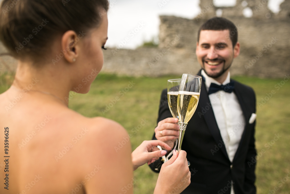 bridal couple clink glasses of champagne bridal couple clink glasses of champagne
