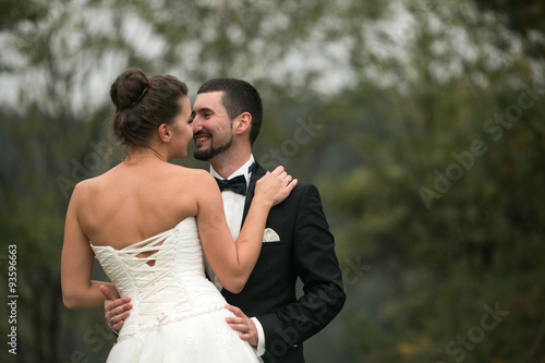 bride and groom dance together in the woods © teksomolika
