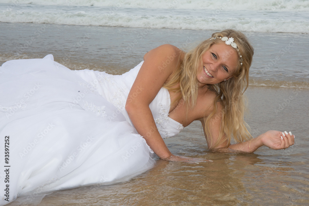 Blond bride woman at the beach at summer time