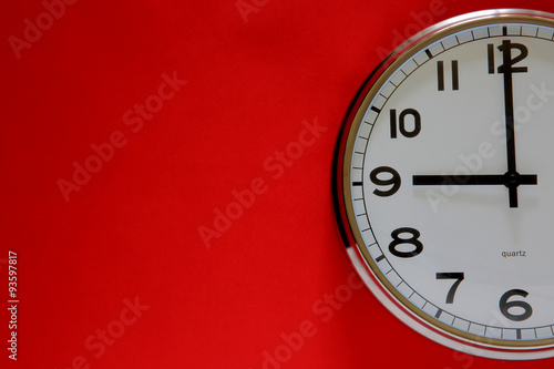 Clock on the red background with space for text