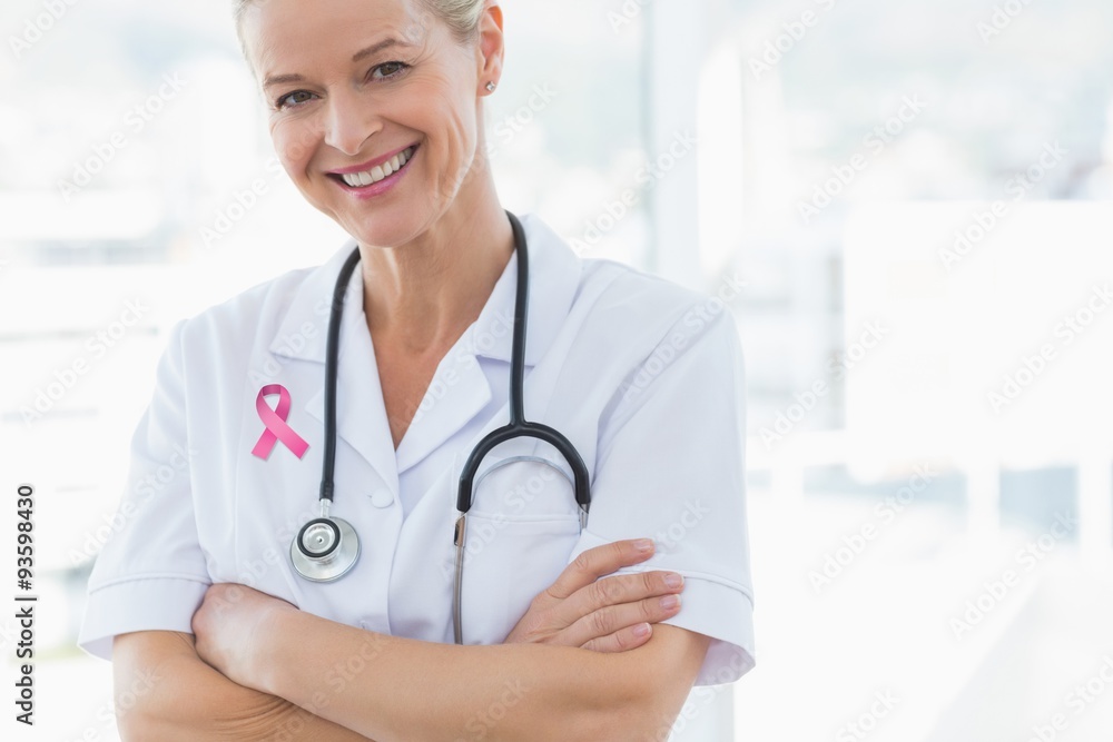 Female doctor with pink ribbon on lab coat Female doctor with pink ribbon on lab coat