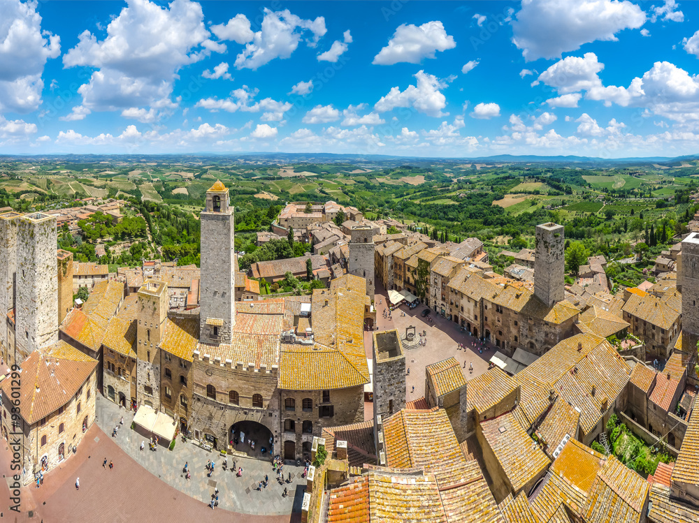 Medieval town of San Gimignano with Tuscan countryside on a sunny day, Tuscany, Italy