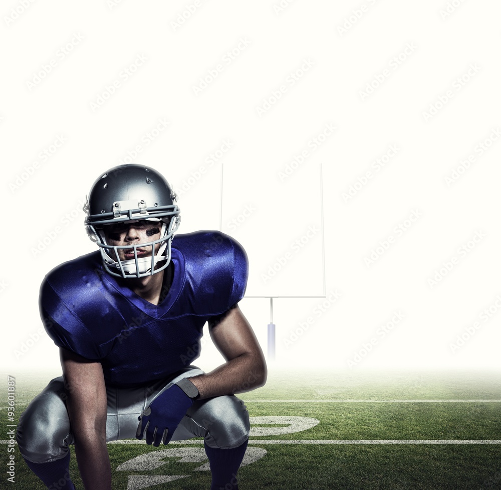 Composite image of american football player in uniform crouching Composite image of american football player in uniform crouching
