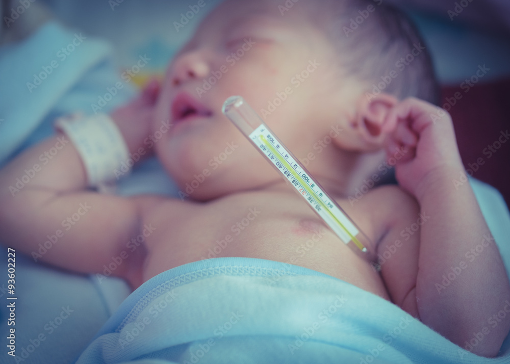Baby Fever. Infant sleeping in bed, measuring temperature to a baby. Classic, vintage, standard thermometer. Baby Fever. Infant sleeping in bed, measuring temperature to a baby. Classic, vintage, standard thermometer.