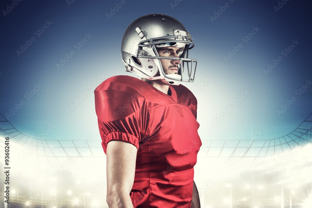Serious american football player looking away