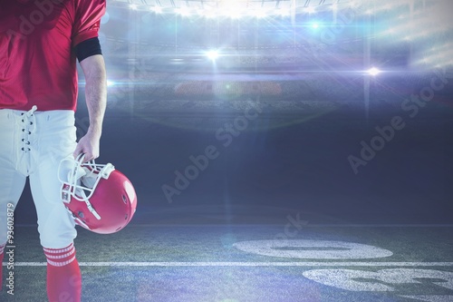 Composite image of american football player holding helmet © vectorfusionart