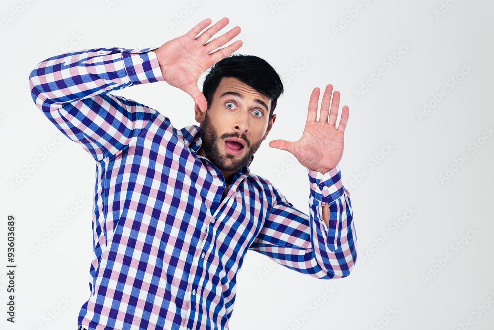 Naklejka premium Portrait of a scared man with raised hands up