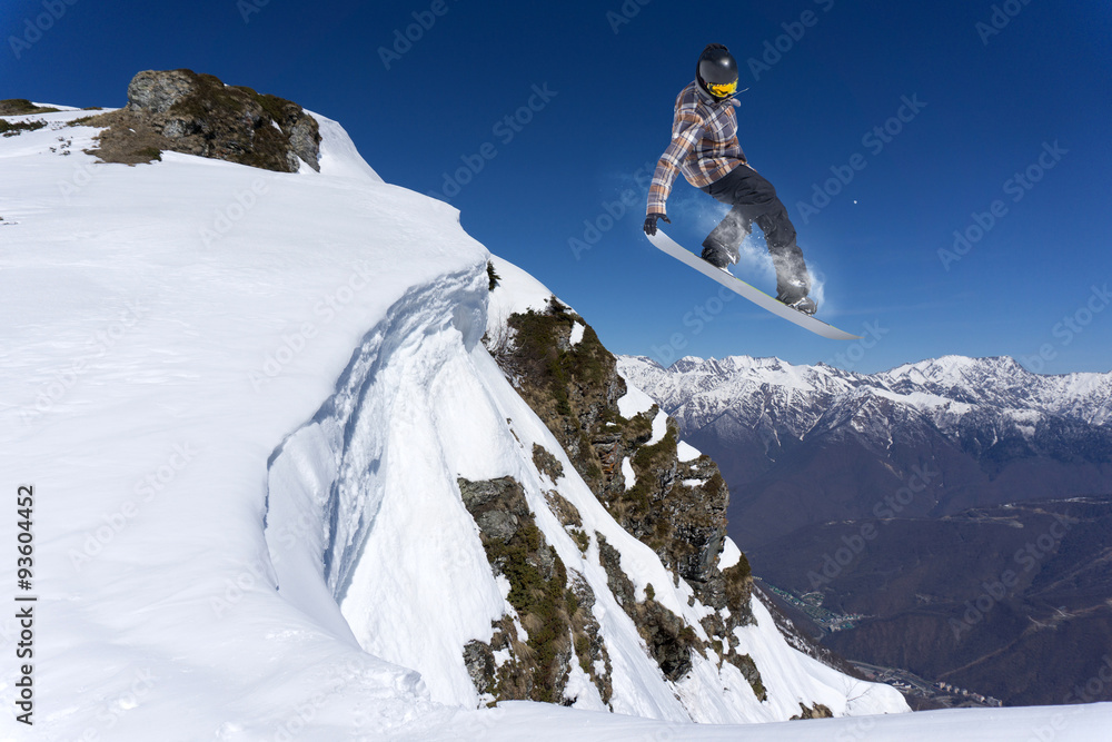 Flying snowboarder on mountains Flying snowboarder on mountains