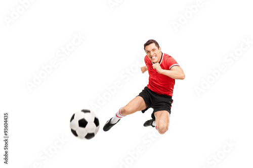 Young football player shooting a football