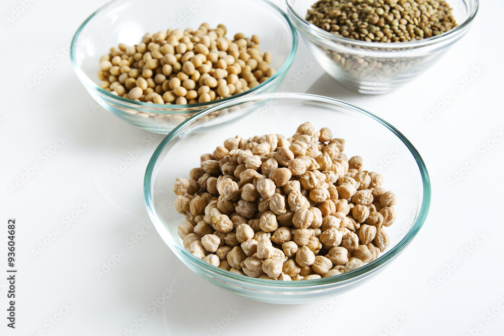 Pile of Chickpeas in bowl and other Legumes on white Pile of Chickpeas in bowl and other Legumes on white
