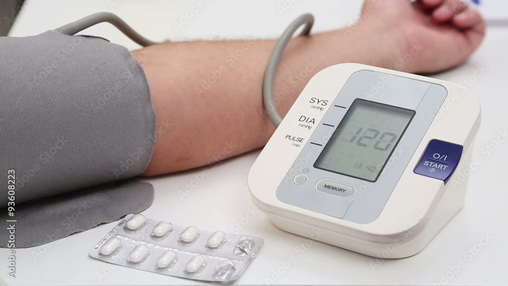 Man measuring his blood pressure at home and the results are good. Man measuring his blood pressure at home and the results are good.