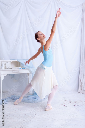 Professional ballet dancer posing on white