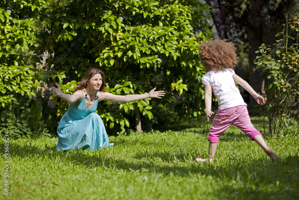 Fototapeta premium Mother and daughter are enjoying on grass at park