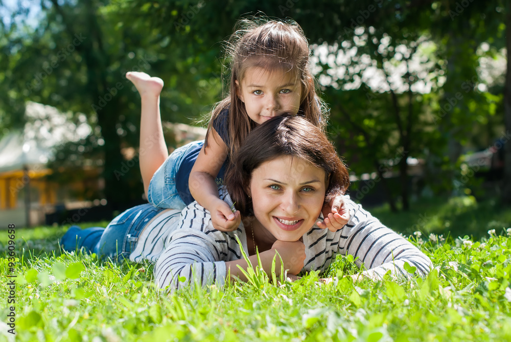 Fototapeta premium Mother and Daughter playing on Green Grass