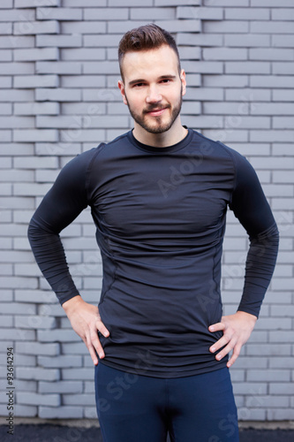 Portrait of smiling man resting after workout outdoors, fit caucasian