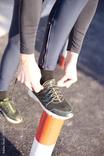 Running and jogging exercising concept. Man tying laces before t