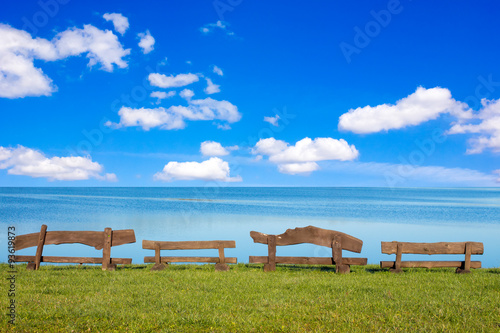 Wooden benches in front of the sea © graja