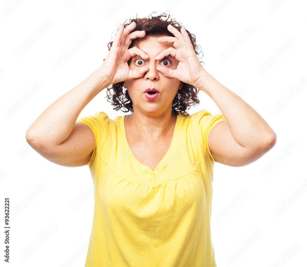 portrait of a mature woman doing a glasses gesture on a white background portrait of a mature woman doing a glasses gesture on a white background