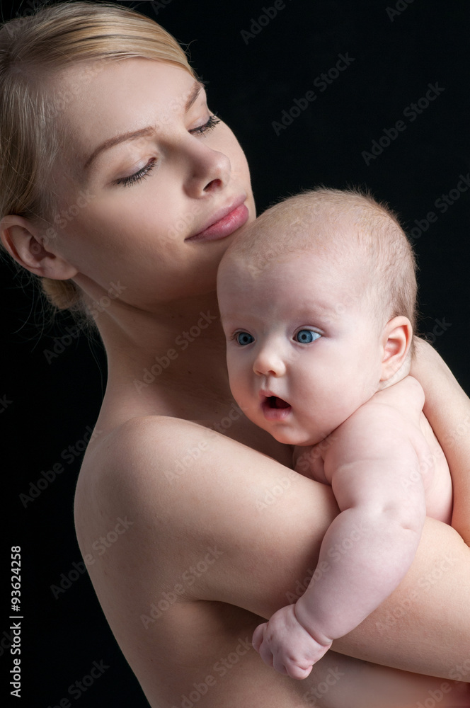 Young mother with a charming baby.Happy family. Mom's love and t Young mother with a charming baby.Happy family. Mom's love and t